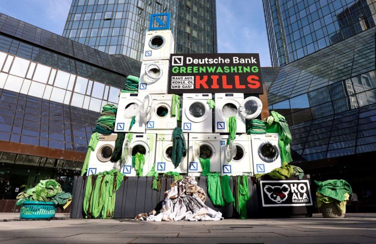 Activists place washing machines in front of the Deutsche Bank headquarters to protest against greenwashing during Deutsche Bank AG Annual Shareholders Meeting in Frankfurt, Germany, May 2022. REUTERS